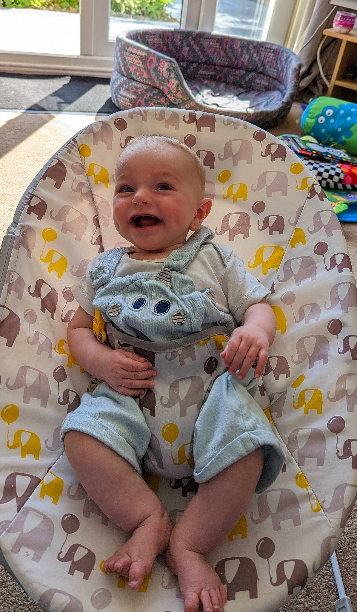 Ethan is registered to the contest to win money with this photo: baby, baby_products, baby_toddler_clothing, chair, child, comfort, face, facial_expression, fun, happy, head, human_body, leisure, person, play, sitting, skin, sleeve, smile, textile