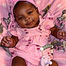 Amira is registered to the contest to win money with this photo: baby, infant, child, portrait, smiling, happy, pink, bow, headband, dress, watermelon_pattern, pacifier, blanket, minnie_mouse, lying_down, indoor, couch, brown_skin, baby_clothing, closeup