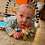 baby, infant, toy, floor, indoor, child, play, colorful, curious, face, hand, clothing, baby_gym, head, mouth, looking, expression, crawling, room, carpet