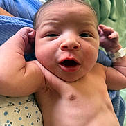 Nazir joined the competition — help win amazing prizes! arm, baby, blanket, blue_cloth, child, close_up, curious, cute, expression, face, hospital_band, human, indoors, infant, lying_down, mouth_open, newborn, skin, soft_light, tiny