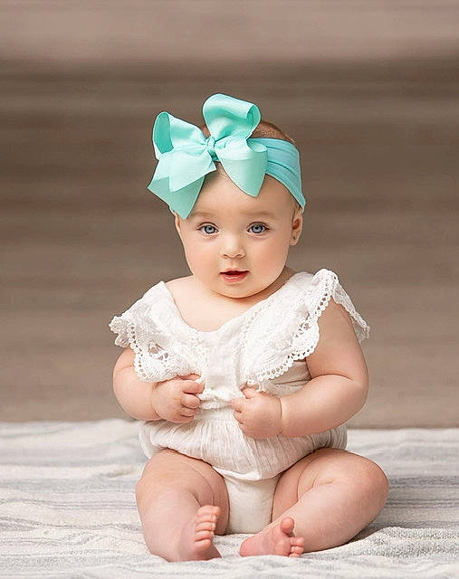 Charli is registered to the contest to win money with this photo: baby, baby_toddler_clothing, cap, embellishment, eye, face, fashion_accessory, flash_photography, foot, grass, hair_accessory, happy, head, headband, headgear, headpiece, headwear, human_body, person, pink