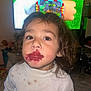 child, toddler, lipstick, smudged_makeup, white_sweater, stains, brown_eyes, curly_hair, indoor, television, cartoon, face, portrait, messy, clothing, person, floor, room, earrings, expression