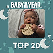 Samiyah is registered to the contest to win money with this photo: baby, infant, child, portrait, smiling, headband, pink, milestone, four_months, wooden_sign, chewing, hands, lying_down, blanket, bed, indoor, moon, stars, baby_of_the_year, top_20