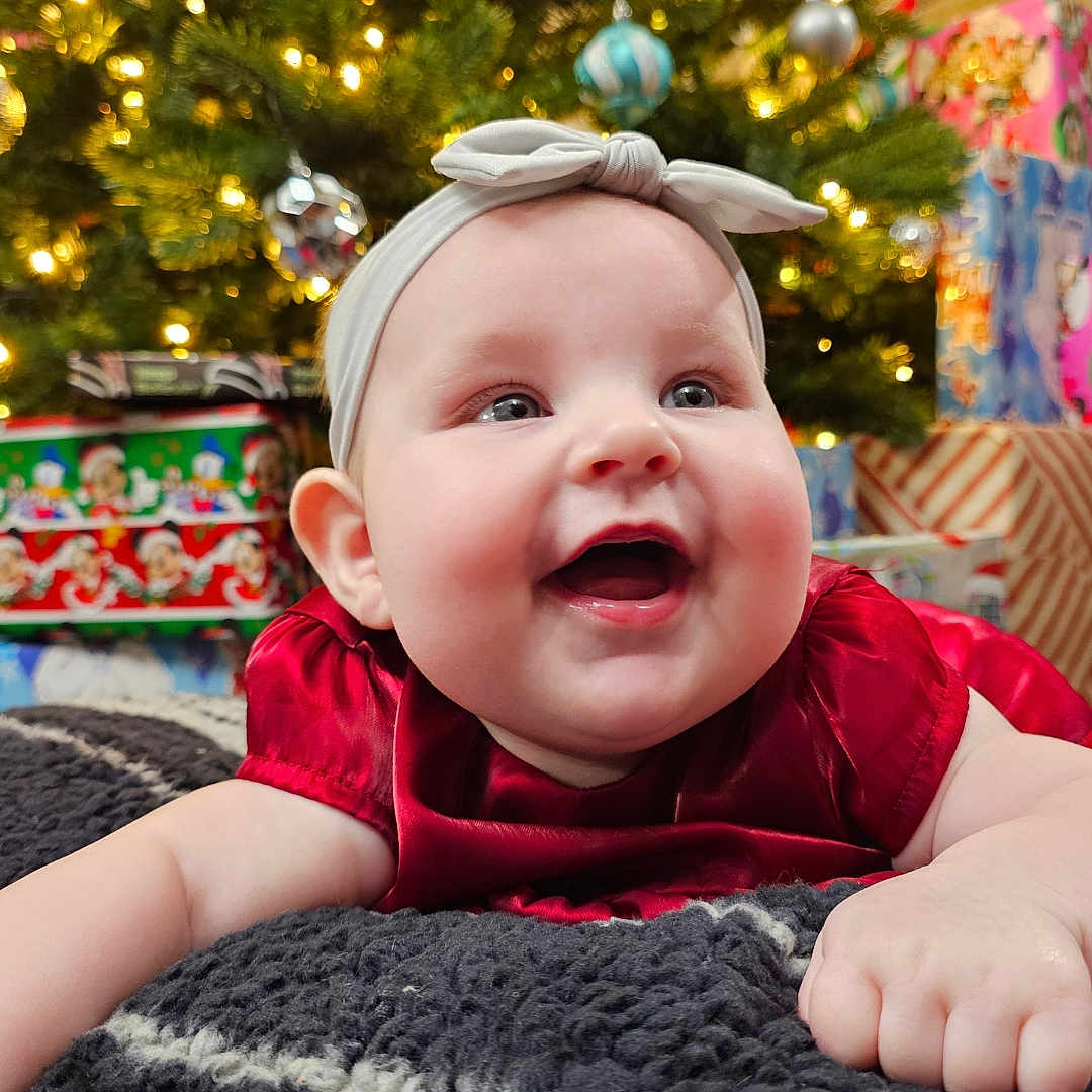 Charlie is registered to the contest to win money with this photo: accessories, baby, cap, clothing, couch, face, fir, furniture, happy, hat, head, laughing, lighting, person, photography, plant, portrait, pottedplant, smile, tree