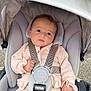 baby, baby_boy, baby_clothes, child, child_seat, clothing, cushion, cute, face, harness, infant, outdoor, person, pink_sweater, portrait, safety, seatbelt, sitting, stroller, young_child