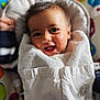 baby, smiling, towel, infant, face, child, happy, cute, indoors, seat, colorful, pattern, clothing, portrait, young, skin, expression, cozy, comfort, fun