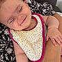 Malia a rejoint le concours — aidez-le/la à gagner de superbes lots ! arm, baby, bib, child, closeup, comfort, cuddle, fabric, hand, indoor, nap, pattern, peaceful, person, polka_dot, portrait, relax, resting, skin, smile