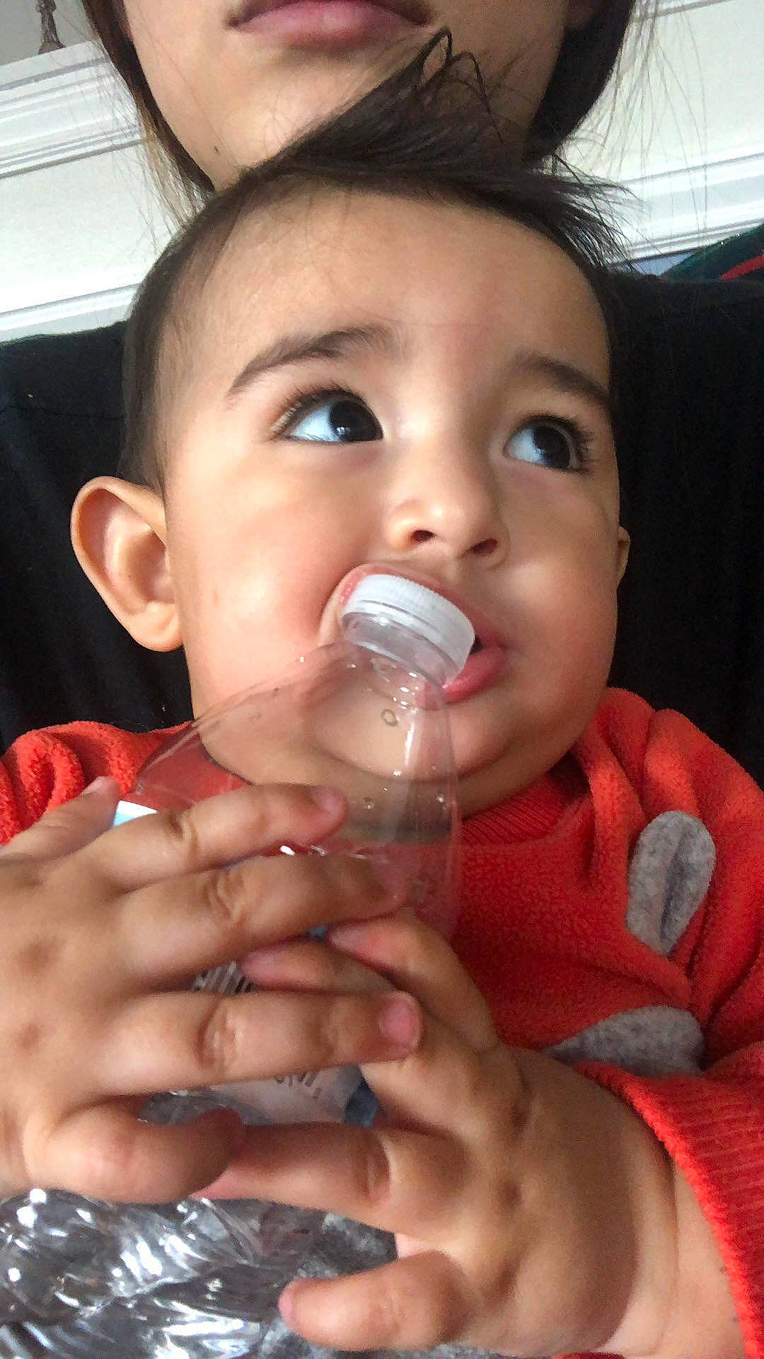 Abraham is registered to the contest to win money with this photo: baby_products, child, drink, drinking, face, finger, hand, lip, mouth, nail, nose, person, product, thumb, toddler, water