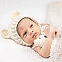 baby, newborn, infant, knitted_hat, bear_ears, blanket, soft_texture, cozy, portrait, close_up, face, cheeks, eyes, hand, wrapped, bed, white_background, cute, warm, nursery
