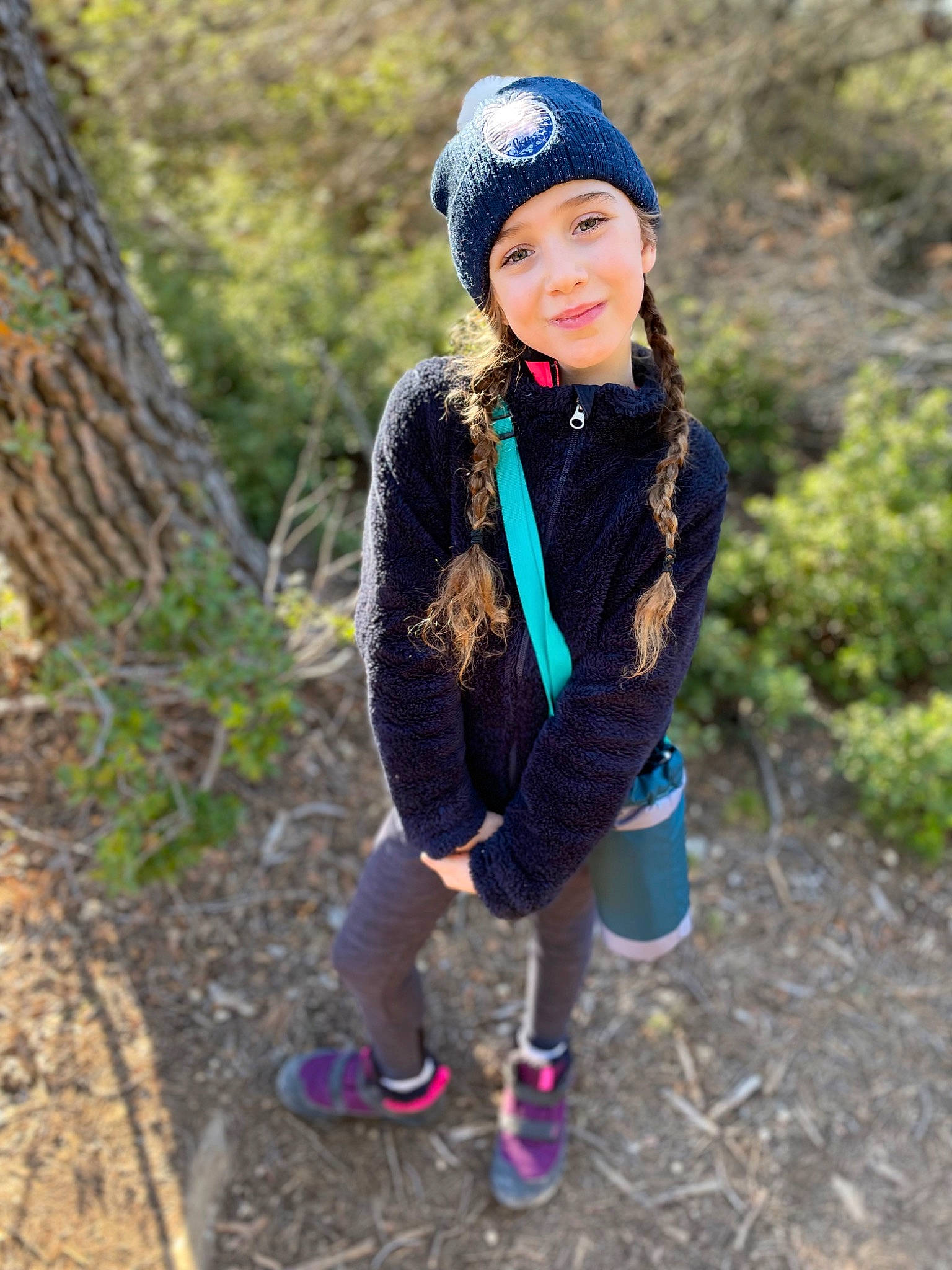Mia participe au concours pour gagner de l'argent avec cette photo : cap, child, clothing, cool, electric_blue, forest, fun, grass, happy, headgear, headwear, joy, knit_cap, leisure, outerwear, pattern, person, plant, recreation, smile