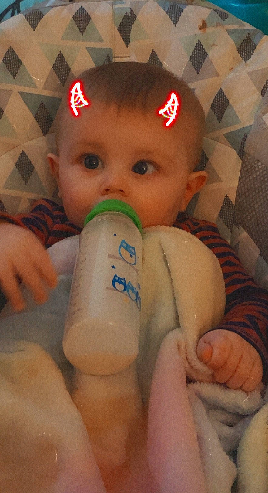 Koah is registered to the contest to win money with this photo: baby, baby_bottle, baby_toddler_clothing, bottle, cap, cheek, chest, drinkware, eyelash, face, finger, gesture, human_body, lip, mouth, nose, person, plastic_bottle, skin, surprise