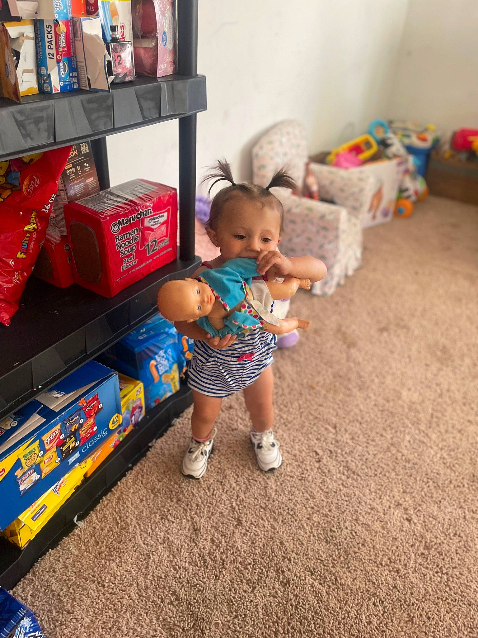 Payton is registered to the contest to win money with this photo: baby, baby_toddler_clothing, box, child, couch, drawer, floor, flooring, fun, human_leg, living_room, person, play, room, sandal, shelf, shelving, shorts, t_shirt, toddler