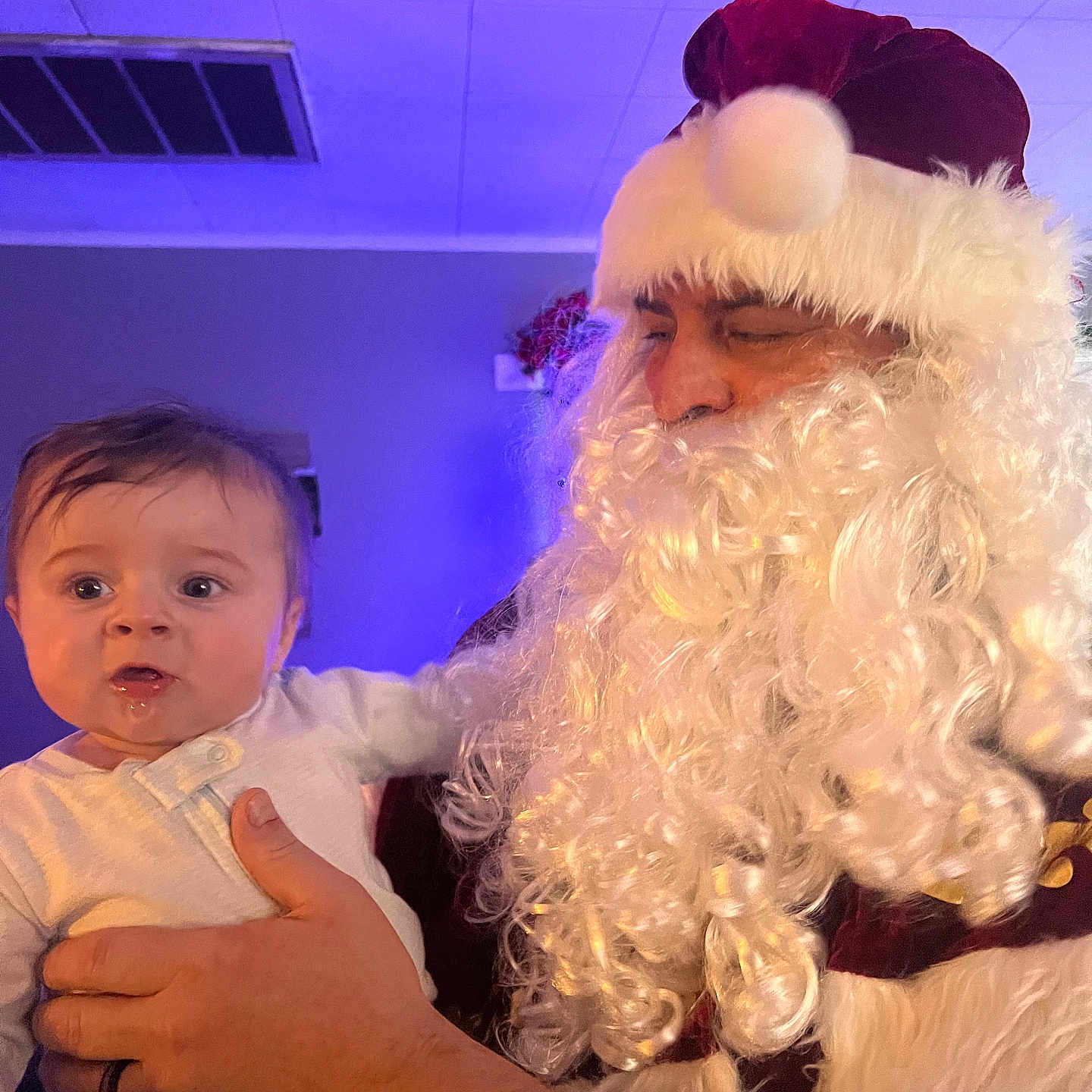 Hayden joined the competition — help win amazing prizes! adult, baby, beard, celebration, child, costume, curious, drool, face, hand, hat, holding, holiday, indoor, lighting, person, portrait, red_hat, santa_claus, white_clothing