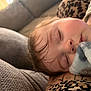 baby, sleeping, blanket, couch, tattoo, leopard_print, face, peaceful, soft_texture, closeup, indoors, child, resting, comfort, cozy, person, nap, young_child, human, portrait