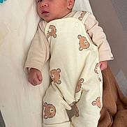Mayronn participe au concours pour gagner de l'argent avec cette photo : baby, newborn, infant, pajamas, bear_pattern, socks, blanket, pacifier, bed, sleeping_area, cute, cozy, soft, clothing, person, portrait, indoors, resting, child, newborn_baby