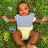 baby, grass, bubbles, outdoor, infant, blue_bib, onesie, greenery, child, cute, smiling, lying_down, nature, playful, summer, sunlight, happy, peaceful, portrait, closeup