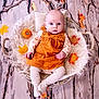 baby, infant, basket, autumn, fall_leaves, pumpkin, orange_dress, corduroy, tights, fluffy_blanket, wooden_floor, cute, portrait, indoor, child, seasonal, decor, cozy, small, sitting