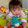 Edie joined the competition — help win amazing prizes! activity_center, baby, blue_eyes, child, close_up, colorful, curious, cute, expression, face, hands, indoor, infant, lion_toy, plastic_toy, play, smile, toy, white_clothing, young_child