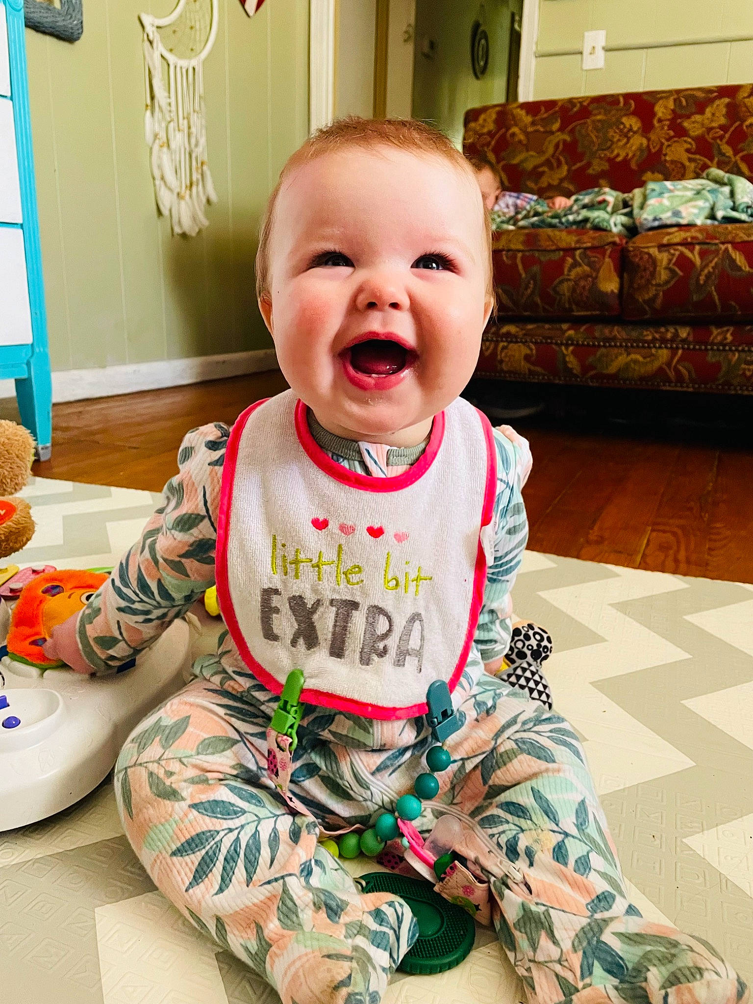 Adalynn is registered to the contest to win money with this photo: baby, baby_toddler_clothing, cheek, child, couch, eye, facial_expression, flooring, happy, pattern, people, person, picture_frame, pink, sitting, skin, sleeve, smile, t_shirt, toddler