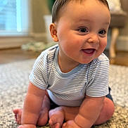Cohen is registered to the contest to win money with this photo: baby, child, crawling, smiling, happy, indoor, rug, carpet, striped_shirt, cute, infant, chubby_cheeks, hands, feet, floor, home, blurred_background, light, portrait, person