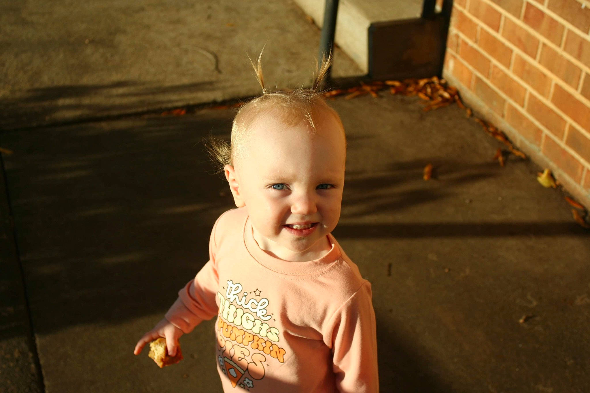 Gracelyn joined the competition — help win amazing prizes! baby, baby_toddler_clothing, brick, brickwork, cheek, child, eye, face, flash_photography, fun, grass, happy, head, joy, person, sitting, sleeve, smile, t_shirt, tints_and_shades