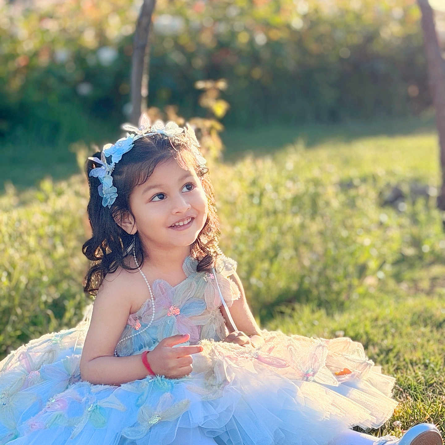 Mishaya joined the competition — help win amazing prizes! child, girl, smiling, dress, flower_headband, outdoor, grass, sunlight, fairy_tale, happy, portrait, cute, young_child, nature, sitting, playful, spring, fashion, costume, childhood