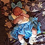 baby, sleeping, blue_dress, headband, bow, white_socks, baby_shoes, blanket, patterned_blanket, infant, cute, resting, small_hands, small_feet, indoors, cozy, soft_lighting, portrait, peaceful, child