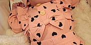 Freya joined the competition — help win amazing prizes! baby, infant, hat, clothing, heart_pattern, blanket, sleepwear, soft_texture, cute, newborn, resting, portrait, indoors, warm, comfortable, child, small_hands, peaceful, couch, fabric