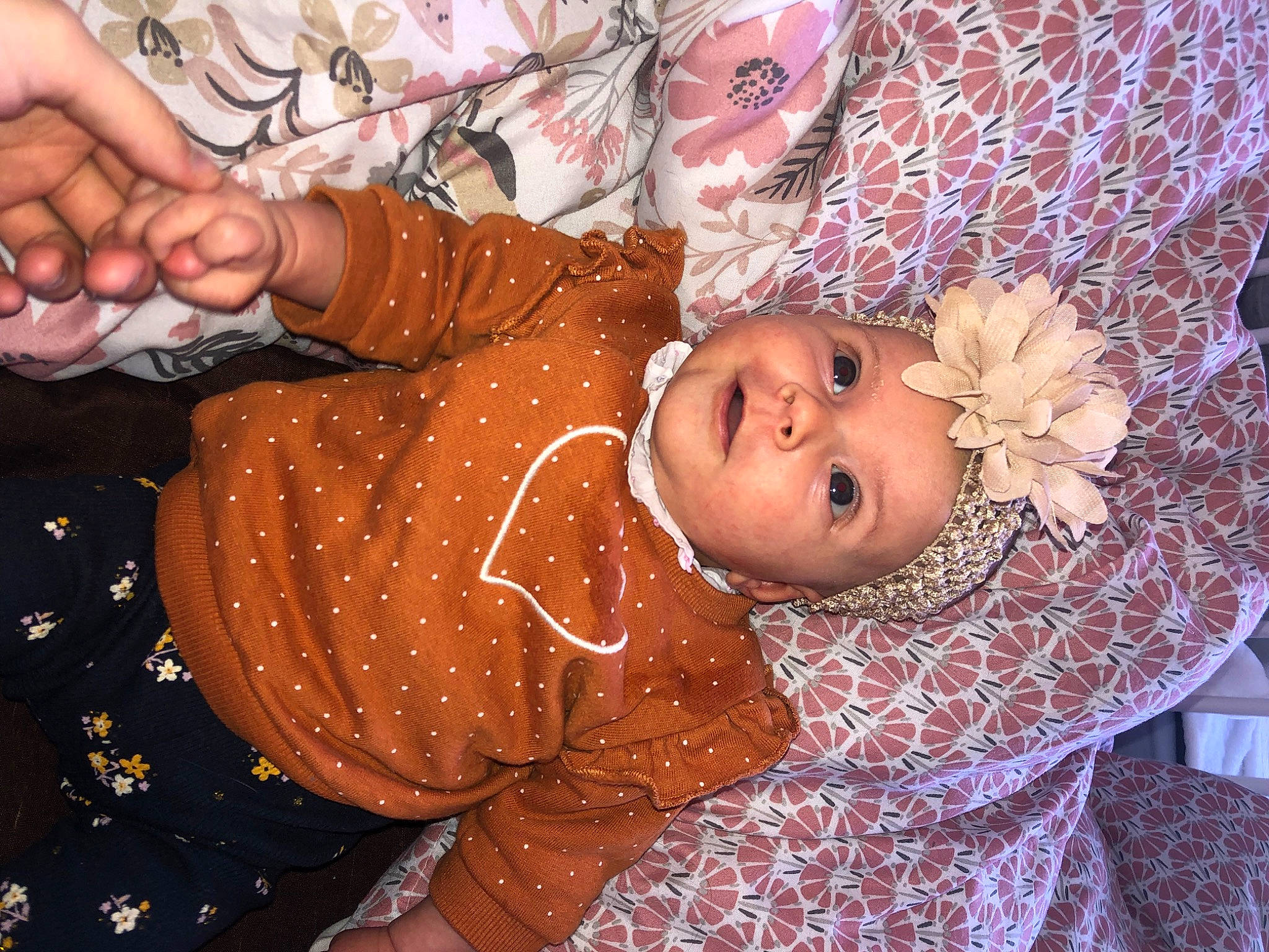 Rose participe au concours pour gagner de l'argent avec cette photo : arm, baby, baby_products, baby_toddler_clothing, cheek, child, eye, fun, happy, hat, human_body, nail, organ, pattern, people, person, pink, room, skin, textile