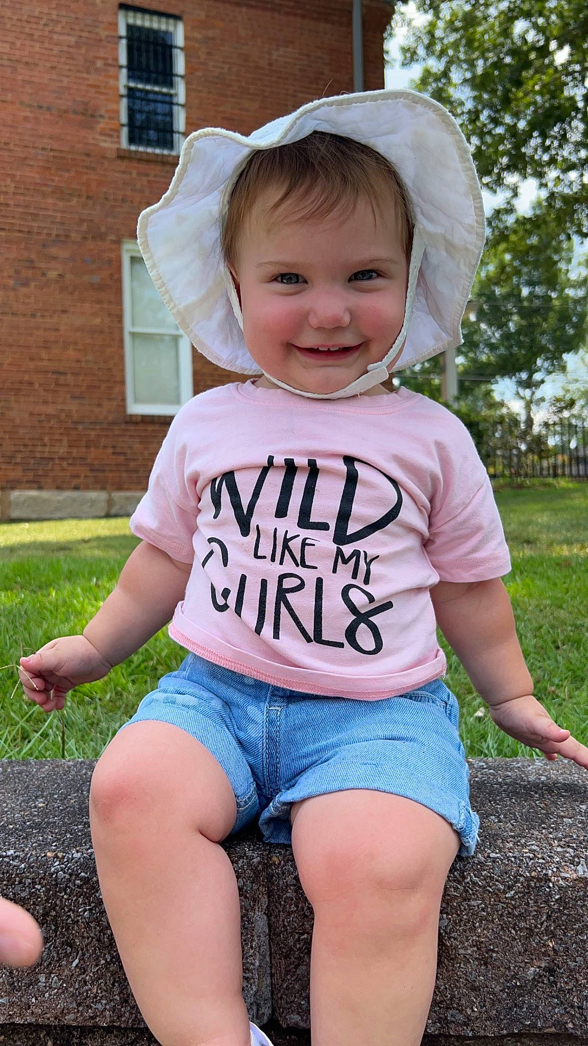 Emberlynn joined the competition — help win amazing prizes! baby_toddler_clothing, cap, child, cool, eye, face, facial_expression, fun, grass, happy, head, joy, leisure, person, pink, public_space, sleeve, smile, standing, summer