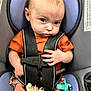 baby, car_seat, child, infant, harness, orange_shirt, plush_toy, pacifier, seatbelt, safety, person, cute, portrait, indoors, young_child, baby_hand, baby_face, car, seat, closeup