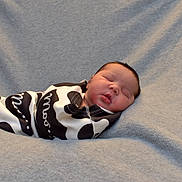 Zara is registered to the contest to win money with this photo: newborn, baby, sleeping, swaddled, blanket, infant, soft, cozy, portrait, peaceful, child, face, resting, cute, human, wrapped, relaxed, indoor, closeup, comfort