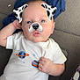 Cavan is registered to the contest to win money with this photo: baby, infant, face_filter, dog_ears, dog_nose, onesie, planets, space_theme, lying_down, carpet, hand, blue_cloth, patterned_fabric, cute, child, portrait, casual, indoor, playful, filter