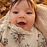 baby, infant, child, portrait, close_up, smiling, happy, open_mouth, face, eyes, bonnet, floral_clothing, lace_collar, outdoor, autumn, bokeh, golden_light, cushion, sitting, photography
