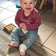 Aryah participe au concours pour gagner de l'argent avec cette photo : baby, carpet, child, cute, face, floor, furniture, happy, home, indoor, jeans, light, person, play, shirt, sitting, smiling, sock, toddler, toy