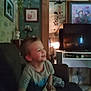 Jace joined the competition — help win amazing prizes! toddler, child, smiling, indoor, living_room, sofa, television, plant, picture_frame, wood_paneling, home_decor, furniture, happy, young_child, casual_clothing, couch, boy, cozy, blurred, portrait