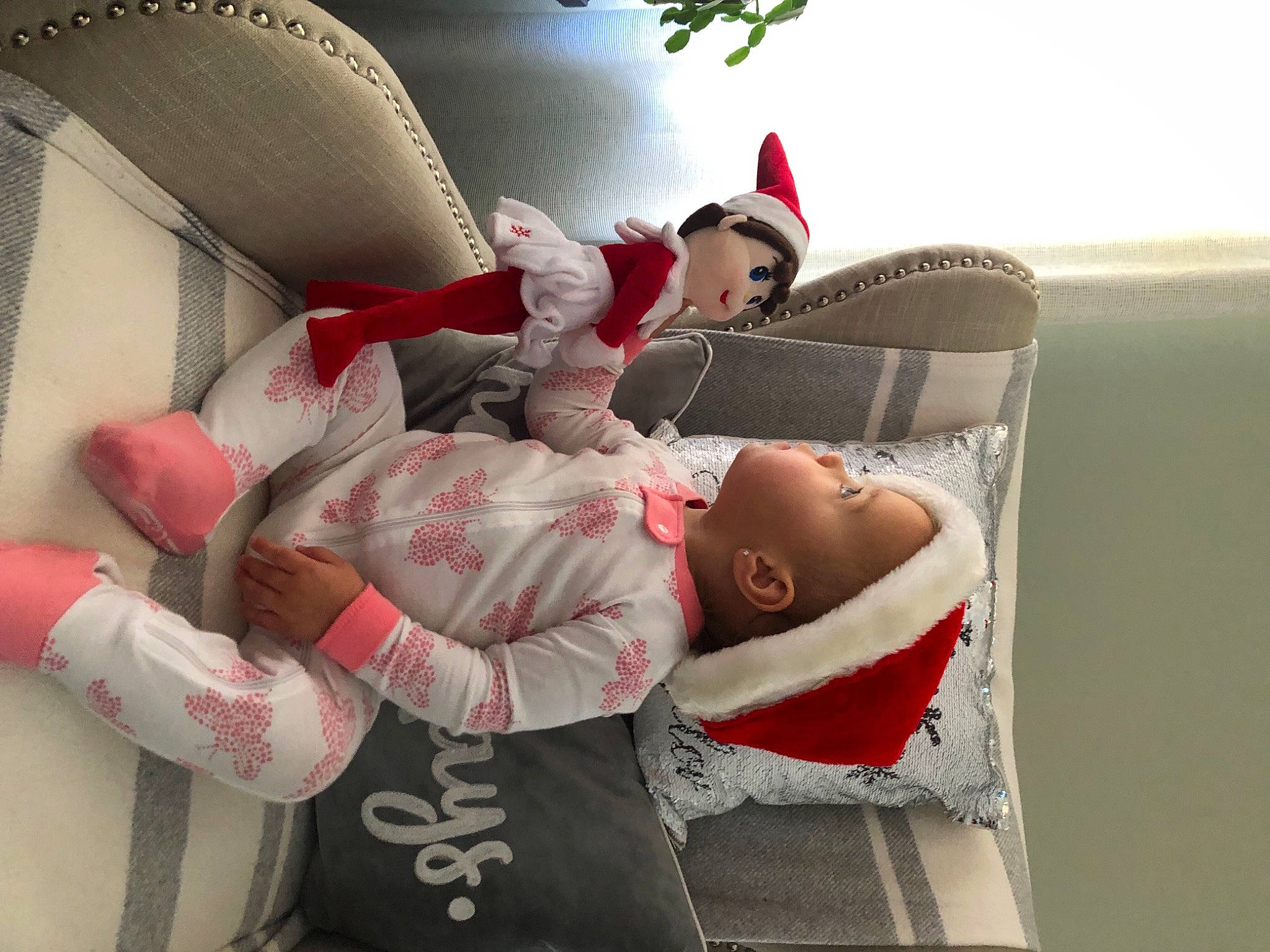 Lana is registered to the contest to win money with this photo: baby, carmine, child, comfort, couch, event, fictional_character, fun, happy, holiday, lap, leisure, pattern, person, picture_frame, room, santa_claus, sitting, toddler, tree