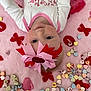 Scarlette is registered to the contest to win money with this photo: baby, infant, face, headband, bow, pink, valentines_day, candy, candy_hearts, blanket, red, white_clothing, cute, child, lying_down, portrait, holiday, festive, soft_texture, colorful
