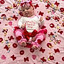 baby, infant, pink_blanket, valentines_day, heart_candies, red_bow, headband, tutu, cute, tongue_out, celebration, holiday, xoxo_pattern, leg_warmers, baby_clothes, festive, lying_down, colorful, soft_texture, adorable