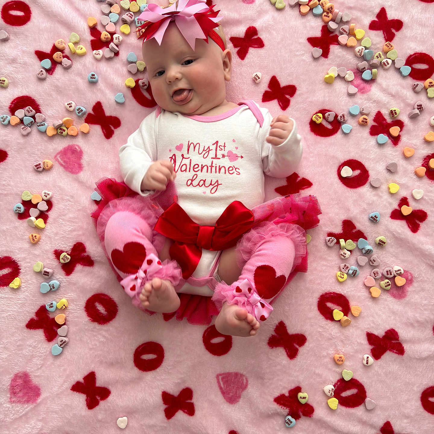 Scarlette joined the competition — help win amazing prizes! adorable, baby, baby_clothes, celebration, colorful, cute, festive, headband, heart_candies, holiday, infant, leg_warmers, lying_down, pink_blanket, red_bow, soft_texture, tongue_out, tutu, valentines_day, xoxo_pattern