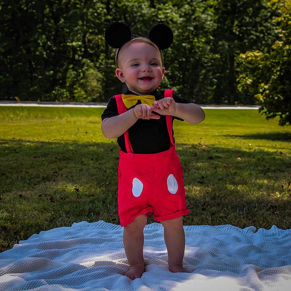 Knox joined the competition — help win amazing prizes! blanket, child, costume, cute, grass, greenery, happy, mouse_ears, nature, outdoor, person, playful, portrait, red_shorts, smiling, standing, summer, sunlight, toddler, yellow_bow_tie