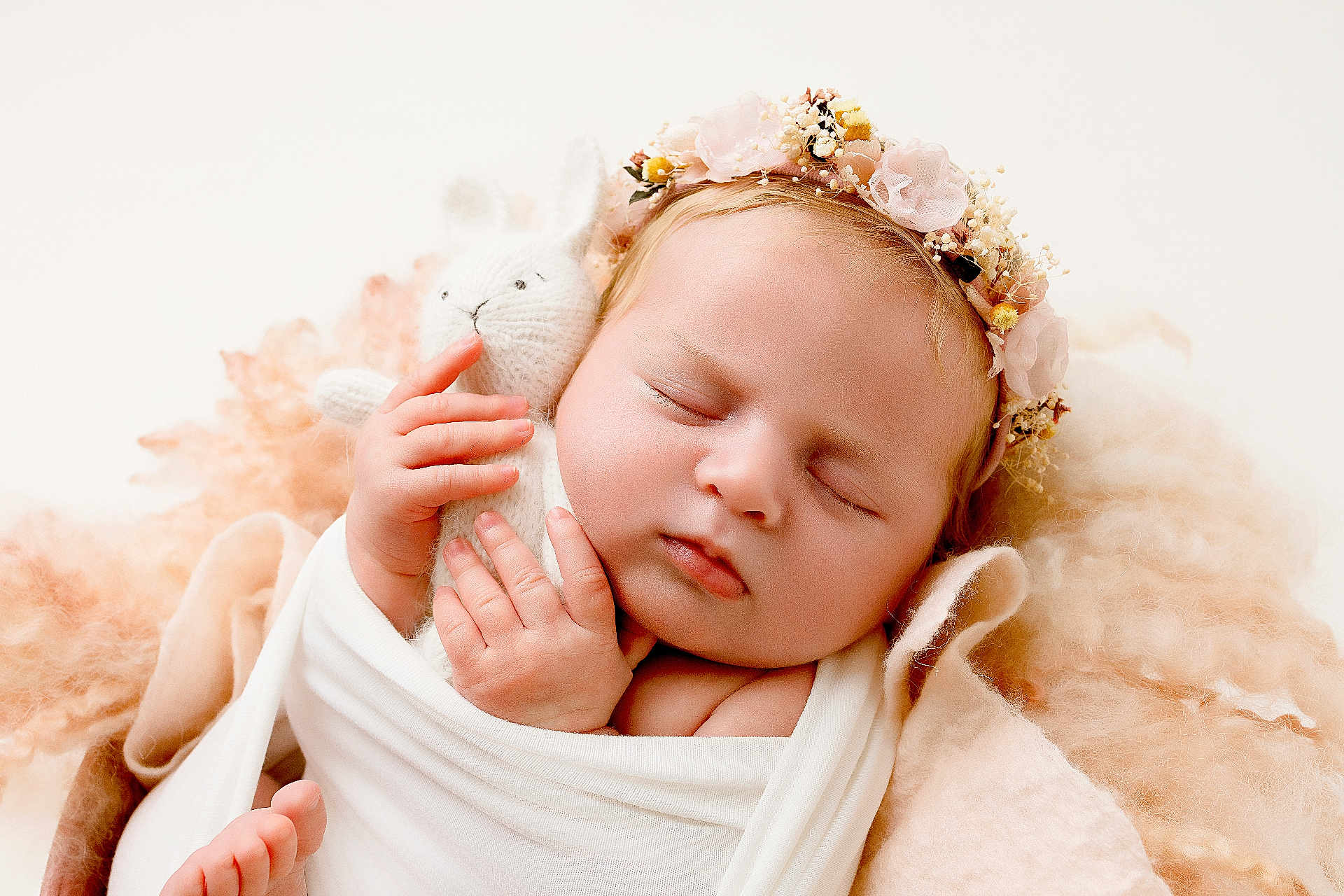 Giorgia participe au concours pour gagner de l'argent avec cette photo : baby, newborn, sleeping, soft_toy, knitted_bunny, flower_headband, wrapped, white_cloth, peaceful, portrait, cute, infant, closeup, soft_background, warm_colors, fingers, toes, cocoon, blanket, adorable