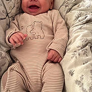 Ruben joined the competition — help win amazing prizes! baby, infant, smiling, onesie, striped_clothing, bear_illustration, blanket, cozy, happy, cute, child, bed, soft, patterned_blanket, lying_down, small_hands, human, indoor, relaxed, joyful