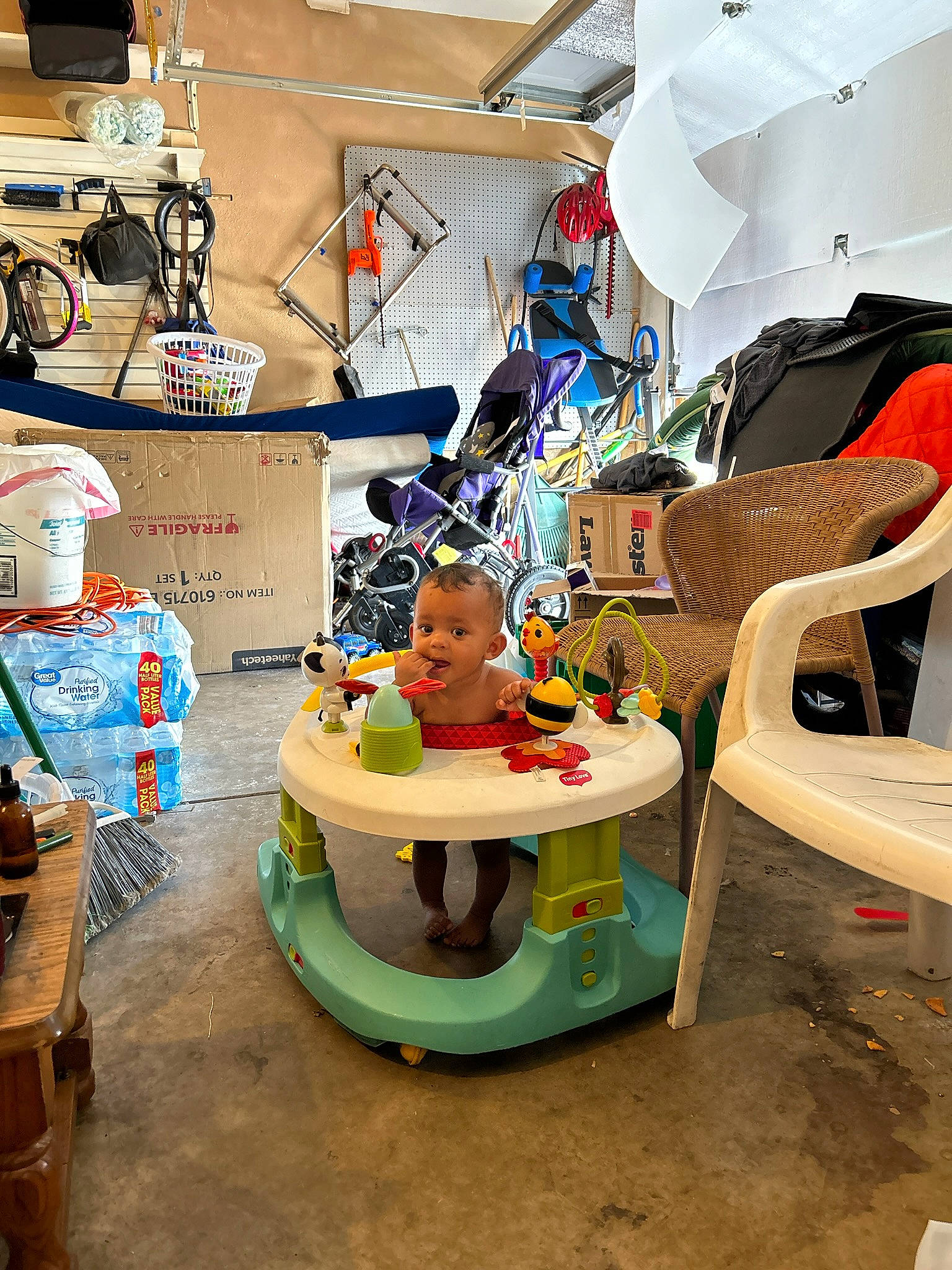 Jaxon is registered to the contest to win money with this photo: amusement_ride, art, baby_products, baby_toys, building, child, fun, leisure, person, plastic, play, recreation, room, shelving, sitting, smile, toddler, toy, toy_vehicle, visual_arts