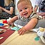 Ryder joined the competition — help win amazing prizes! baby, smiling, play_mat, toy, indoor, person, child, happy, arm, face, adult, woman, man, floor, clothing, tattoo, reaching, cute, infant, casual