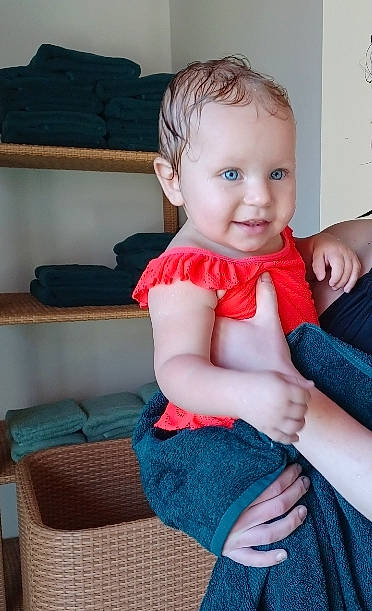 Alanni is registered to the contest to win money with this photo: arm, azure, baby, baby_toddler_clothing, blue, cheek, clothing, finger, head, human_body, iris, joint, joy, neck, person, shoulder, skin, sleeve, smile, standing