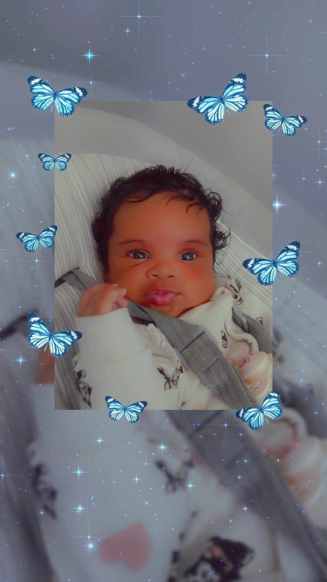 Amy-Rose is registered to the contest to win money with this photo: baby, infant, face, curly_hair, blanket, butterfly, stars, sparkles, cute, cozy, clothing, closeup, portrait, soft_lighting, indoors, child, expression, whimsical, fantasy, babywear