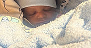 Tru is registered to the contest to win money with this photo: baby, sleeping, blanket, hat, infant, cozy, soft, cushion, face, peaceful, child, newborn, wrapped, comfort, indoors, closeup, warm, cute, portrait, resting