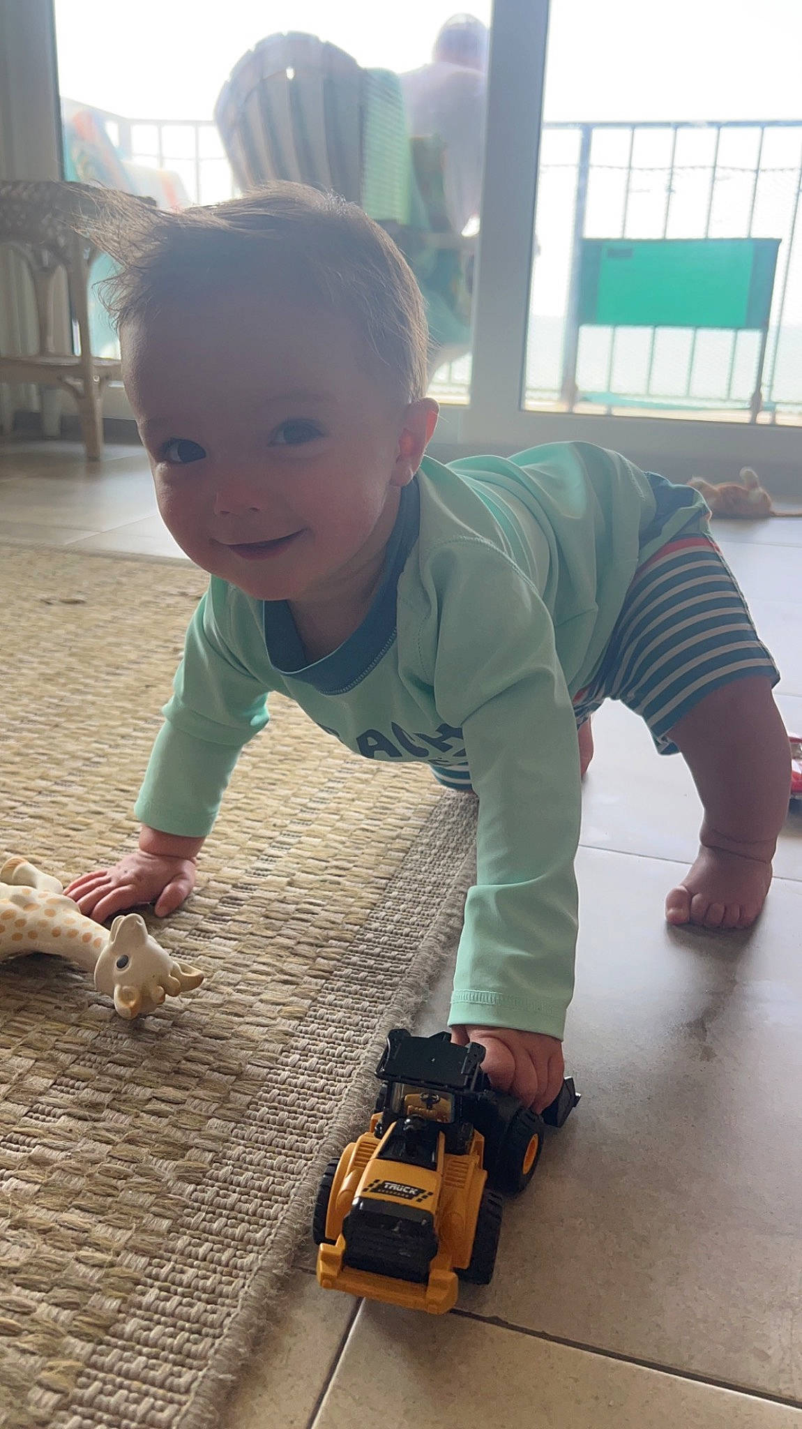 Kohen joined the competition — help win amazing prizes! asphalt, baby, baby_toddler_clothing, child, crawling, floor, flooring, fun, grass, hardwood, joy, person, plant, rolling, sleeve, smile, standing, t_shirt, toddler, toy