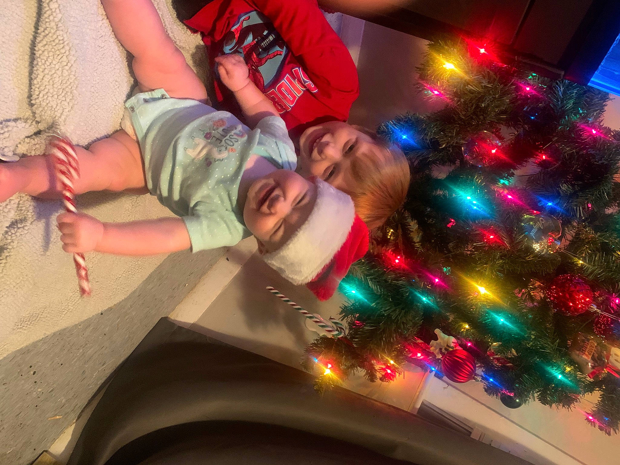 Adalynn is registered to the contest to win money with this photo: christmas, christmas_decoration, christmas_ornament, christmas_tree, cool, event, eyewear, fun, happy, hat, headwear, holiday, holiday_ornament, joy, leisure, ornament, person, plant, selfie, shorts